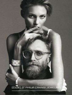 a black and white photo of a woman holding a man's head with the caption, designed by philip crangi jewelry