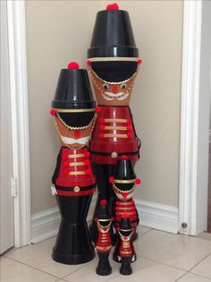 two large wooden nutcrackers sitting next to each other on the floor in front of a door