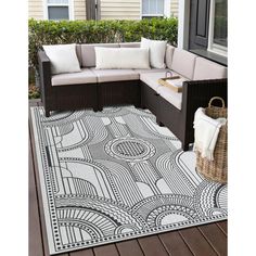 an outdoor area rug with black and white designs