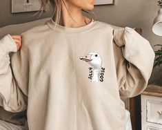 Are you a proud silly goose or know someone who is? This playful "Silly Goose" sweatshirt is the perfect way to show off your fun-loving spirit! Whether you're a goose enthusiast or simply appreciate a good laugh, this comfy sweatshirt is sure to be a hit. About this sweatshirt: Unisex heavy blend crewneck sweatshirt Made from 50% cotton and 50% polyester Ribbed knit collar retains shape after washing No itchy side seams for a more comfortable fit Classic fit with double-needle stitching for add Goose Sweater, Goose Sweatshirt, Silly Goose, Comfy Sweatshirt, Fun Loving, Funny Sweatshirts, Knit Collar, Unisex Sweatshirt, Crewneck Sweatshirt