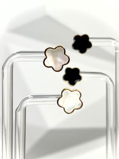 Add a touch of elegance and playfulness to your outfit with our Gold Clover Earrings. Made of 18k gold plated stainless steel, these earrings will dazzle and dance in the light, making your earlobes the star of the show! Perfect for both daytime adventures and nighttime escapades. How about you indulge in the luxurious choice of either black or white pearl? Or why not both?😍 Features: 18k Gold Plated High-Quality Stainless Steel Tarnish Free Modern Flower Shaped Earrings For Gift, Trendy Hypoallergenic Gold Flower Earrings, Trendy Nickel Free Flower Shaped Earrings, Trendy Nickel-free Flower-shaped Earrings, Trendy Flower-shaped Earrings For Gift, Clover Earrings, White Pearl, The Star, Night Time