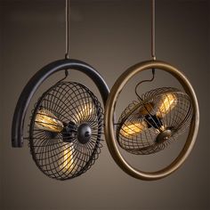 two lamps hanging from the ceiling with circular lights in them, one being an electric fan