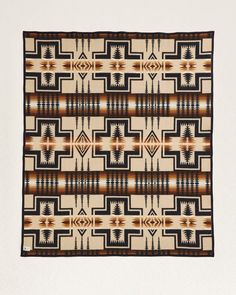 an old navajo rug with geometric designs on the front and back sides, in brown, black