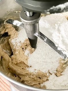 a mixing bowl filled with batter and powdered sugar