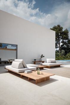 an outdoor living area with couches and tables