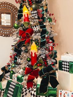 a decorated christmas tree with candles and presents