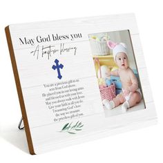 a wooden frame with an image of a baby on it and the words may god please you