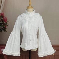 This price is for a shirt only, others are not included. Collar:Ruff CollarDress / Top Details:Front Button Placket / Lace Trim / Pleating Details / Ruffle TrimMaterial:Cotton / PolyesterSleeves:Balloon Sleeves / Bell Sleeves / Tie Closures Cuffs Size S M L XL 2XL Shoulders 35 36 37.5 39 40.5 Bust 84 88 92 96 100 Waist 70 74 78 82 86 Sleeve Length 59 60 61 62 63 ... Fitted White Shirt With Ruffles, Fitted Collared Shirt With Ruffles, White Collared Shirt With Ruffles, Fitted White Shirt With Ruffled Collar, White Fitted Shirt With Ruffled Collar, White Ruffled Collared Shirt, Cotton Shirt With Ruffles, Fall White Shirt With Ruffles, Fall White Ruffled Shirt