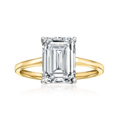 an emerald - cut diamond ring in yellow gold