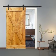 an open sliding door in a living room with a chair and vase on the floor