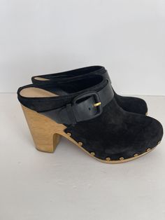 Elevate your shoe collection with these stunning Veronica Beard Dacey Clogs. The black suede upper material gives a chic and elegant look, while the almond toe shape complements the stylish design. The high block heel style gives a perfect lift to your stride. These designer and bohemian-themed clogs have gold studs and buckle feature that add to their charm. These clogs are perfect for any occasion, and their vintage look makes them a must-have. MSRP $400 New in box-tried on but never worn. Comes with dust bag. I also have a pair in brown-see my other listing. Suede Closed Toe Platform Clogs, Chic Suede Platform Mules, Black Almond Toe Clogs For Formal Occasions, Formal Black Almond Toe Clogs, Chic Suede Clogs With Stacked Heel, Chic High Heel Clogs For Work, Chic Formal Clogs With Reinforced Heel, Suede Platform Mules With Block Heel, Suede Mules With Stacked High Heel