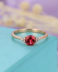 Round Cut Diamond Ring With Accent Stones For Proposal, Rose Gold Ruby Ring With Center Stone For Anniversary, Red Center Stone Wedding Proposal Ring, Rose Gold Sapphire Ring For Proposal, Rose Gold Ruby Rings For Proposal, Rose Gold Ruby Promise Ring Brilliant Cut, Wedding Solitaire Ruby Ring, Wedding Ruby Solitaire Ring, Rose Gold Ruby Ring With Brilliant Cut For Promise