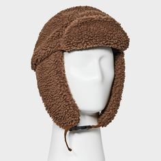 Take on the winter season in style with this Polyester All Over Faux Shearling Trapper Hat from Goodfellow & Co™. Made from a heavyweight woven fabric and filling, this faux shearling trapper hat offers your head and ears all-day cozy comfort. Designed with a chinstrap hook-and-loop fastener for a snug fit, it makes a standout addition to your collection of winterwear. Goodfellow & Co™: Feel good in what you wear, anywhere. Brown Hat With Plush Lining For Cold Weather, Brown Aviator Winter Hats, Brown Winter Hats, Winter Brown Aviator Hats, Brown Hats With Fleece Lining For Cold Weather, Winter Brown Hats With Plush Lining, Brown Insulated Winter Hat, Brown Faux Fur Hats For Outdoor, Brown Faux Fur Outdoor Hats