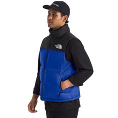 Check the streets of any major city in the world and you’ll see more North Face than you can keep up with. Their legacy of technical innovation, performance, and style might have been made for the peaks, forests, and trails, but it resonates just as strong on the beaten path. 100% Recycled Polyester Lining: 100% Nylon 700 fill goose down Attached, stowable, three-piece hood packs into stand collar Exposed, VISLON® center front zip Secure-zip hand pockets Stows in right hand pocket Bungee cinch-c Nuptse Vest, The North Face 1996 Retro Nuptse, The North Face 1996, North Face 1996, Equatorial Guinea, British Indian, Three Piece, Right Hand, Laos