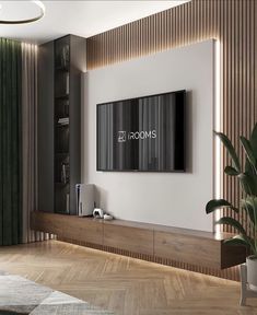 a living room with a large television mounted on the wall and a plant next to it