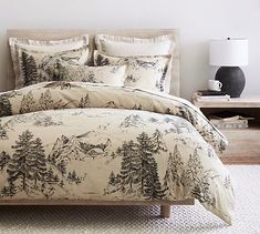 the comforter is made up with pine trees on it