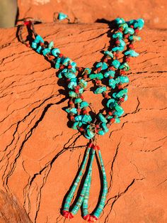 A traditional Pueblo jewelry adornment, a jacla is two loops of heishi that were originally earrings and sometimes fastened to the bottom of a stone necklace as a pendant-like attachment. Jacla is Navajo for “ear string”. Although jaclas are attributed to the Rio Grande Pueblo Indians, they were traded with other tribes so have become associated with the Navajo as well. In the oldest style necklaces, the jacla is a pair of loop earrings tied onto the necklace. The two loops would be removed from the necklace and used as earrings. This is how the jacla originated. I can just picture a pre-European-contact Rio Grande Puebloan taking his or her jewelry off and storing it that way. And sometimes when I not wanting to wear earrings, just leaving the jacla on the necklace as a pendant. The jacla Bohemian Dangle Jewelry With Polished Beads, Turquoise Hand-strung Lariat Jewelry, Hand-strung Turquoise Lariat Jewelry, Turquoise Lariat Hand-strung Jewelry, Artisan Lariat Jewelry With Gemstone Beads, Artisan Gemstone Beads Lariat Jewelry, Artisan Lariat Gemstone Beads Jewelry, Artisan Dangle Jewelry With Polished Beads, Southwestern Double Strand Beaded Necklaces