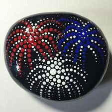 a painted rock with red, white and blue designs on it's surface is shown