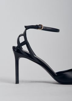 Round toe d'orsay heel in calfskin leather. Contrast basket weave counter. Adjustable ankle strap with brass buckle. Made in Italy. Details 100% Calfskin Black 0511AGN-BLA True to size Heel height: 87mm approx 3.5" Ankle Strap Sandals With 4-inch Heel For Galas, Luxury Heel Strap Sandals For Work, Evening Calf Leather Heels With Buckle Closure, Evening Closed Toe Court Shoes With Buckle Closure, Evening Closed Toe Court Shoes With Buckle, Evening Heels With Buckle Closure In Calf Leather, Evening Court Shoes With Buckle Closure, Luxury Ankle Strap Heels With Leather Sole, Luxury Heels With Leather Sole And Ankle Strap