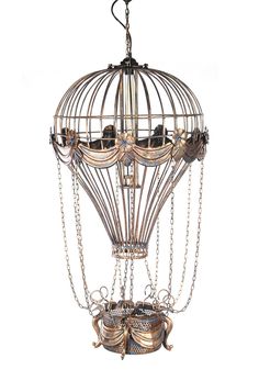 an ornate birdcage chandelier is hanging from the ceiling