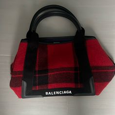 Balenciaga Red Navy Cabas Wool Tote Bag Black This Bag Is Constructed Out Of Multicolor Plaid Wool And Trimmed In Calfskin Leather With A Long Detachable Crossbody Strap For Hands Free Styling. Its Interior Is Lined In Canvas And Includes A Detachable Pouch For Small Trinkets. Red Leather-handled Shoulder Bag For Business, Designer Red Business Bag, Red Leather Handles Shoulder Bag For Business, Red Leather Handle Shoulder Bag For Business, Designer Red Shoulder Bag For Travel, Designer Red Bags For Errands, Designer Red Business Shoulder Bag, Designer Red Shoulder Bag For Business, Designer Red Bag For Everyday Use