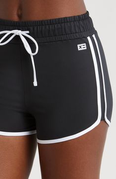 You will move with ease from land to sea in these stretch-enhanced swim shorts topped with a high waist. 3 1/2" inseam   Lined   80% recycled polyester; 20% spandex   Hand wash, line dry   Imported Black Swimwear With Built-in Shorts, Black Athleisure Swim Skirt With Built-in Shorts, Sporty High Waist Swim Skirt With Built-in Shorts, Sporty Black Swimwear With Built-in Shorts, High-waisted Swim Shorts With Elastic Waistband, Summer Style Short Length Activewear For Swimming, Beachwear Swimwear For Workout In Short Length, Short Swimwear For Workout During Beach Season, Sporty Poolside Bottoms With Elastic Waistband