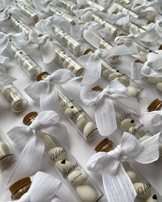 white wine bottles with bows and labels on them are lined up in the shape of hearts