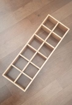 a wooden shelf sitting on top of a hard wood floor