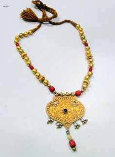 "Vintage antique tribal old solid gold and red color touchstones beads necklace. Fully handmade collection piece in good condition. Length-32 cm(12.6\") free size, easy to adjust the length by moving toggle. Size of pendant-9/6 cm, weight-62.350 grams." Gold Beaded Necklaces With Latkans For Festivals, Temple Jewelry Necklaces With Large Beads For Festivals, Traditional Adjustable Bronze Beaded Necklaces, Festive Traditional Necklaces With Large Beads, Traditional Adjustable Bronze Beaded Necklace, Bronze Adjustable Beaded Necklaces, Traditional Style, Antique Beaded Necklace For Festivals, Traditional Gold Beaded Necklaces With Latkans, Traditional Adjustable Gold Kundan Necklace