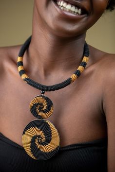 Unique African Maasai Handcrafted Beaded Necklace with an Elegant Look and Brilliant Finish. **GET FREE SHIPPING FOR ADDITIONAL ITEMS PURCHASED. Size(Around the Neck)-16 Inches. Color-Gold and Black. Get a pair of Matching Earrings and 2 Bracelets for an extra $7. Yes, Buy Multiple Items and pay shipping for 1 item only- The rest ships Free. (No Limits on the number of Multiple items). With a faster delivery time of 3 days via DHLExpress, Worldwide. Ordinary/Standard Shipping also available upon Artisan Black Necklace With Beaded Chain, Artisan Black Beaded Chain, Yellow Necklace With Round Black Beads, Unique Statement Necklace, Woman Necklace, Cowrie Shell Necklace, Handmade Beaded Necklace, Celtic Necklace, Acanthus Leaves