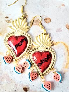 Detailed and beautiful hand painted earrings with the sacred heart with thorns and decorated with small slices of watermelon. The earrings are protected with several layers of high-quality jewelry varnish, improving the quality and durability of the earrings. These earrings are inspired by our Mexican culture and hand painted; They are the ideal gift because they combine with any outfit both day and night, enhancing the beauty of the person who receives them and attracting attention for being unique hand-painted pieces, the Ideal gift for Mother's Day and holidays. Features/ Product info Note: Each earring is hand painted, there are small differences between each pair, so each pair of earrings in this store is unique. -Large: 2 in  (Please see the photos, this design comes in two sizes.) - Handmade Heart-shaped Jewelry For Festivals, Handmade Heart-shaped Enamel Earrings, Handmade Heart-shaped Enamel Jewelry, Handmade Artisan Heart Earrings, Hand Painted Dangle Heart Earrings As Gift, Unique Hand Painted Heart Earrings, Artistic Handmade Heart Earrings For Gift, Artisan Hand Painted Heart Jewelry, Artisan Hand-painted Heart Jewelry