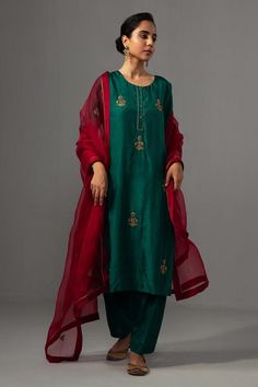 Emerald green kurta with floral hand embroidery and side slits detailing. Paired with pant and dupatta.
Components: 3
Pattern: Embroidered
Type Of Work: Floral
Neckline: Round
Sleeve Type: Three quarter
Fabric: Kurta: Silk,  Pant: Dupion Silk, Dupatta: Silk Organza, Lining: Cotton
Color: Green
Other Details: 
Side slits detailing
Placket
Attached lining
Length : 44 inches
Weight : 1 kg
Occasion: Wedding - Aza Fashions Chanderi Dupatta, Chanderi Suits, Dupion Silk, Indian Heritage, Silk Suit, Color Fuchsia, Kurta With Pants, Silk Organza, Embroidered Silk