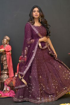 Plum Purple mirror work lehenga choli Matched with Purple mirror work blouse with quarter sleeves. Designed with round neck and has back hooks. Set together with a matching soft net purple duppata with mirror work and have gold border The length of the blouse is 14 inches. Blouse can fit a size 32 to 42 The maximum length of the lehenga will be 41 inches. Slight variation in color is possible due to digital photography. This is a 3 piece set. Care: dry clean only We provide side fitting/sleeves Purple Lehnga Design, Diwali Chandbali Sets With Mirror Work, Purple Gota Work Dresses For Navratri, Festive Chinon Choli With Mirror Work, Purple Sets With Sheer Dupatta For Navratri, Purple Dupatta With Gota Work For Diwali, Purple Gota Work Dupatta For Diwali, Festive Purple Traditional Wear With Gota Work, Purple Georgette Sets With Zari Work