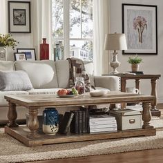 a living room filled with furniture and a coffee table on top of a wooden floor