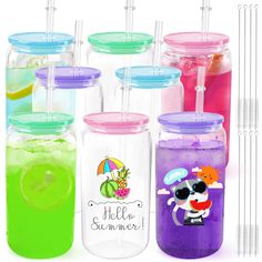 there are many different colored drinks in the glass jars with straws on each one