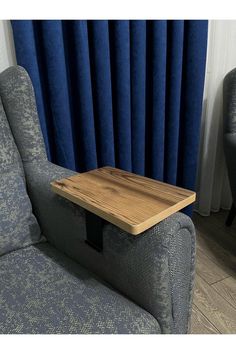 a wooden table sitting on top of a blue couch