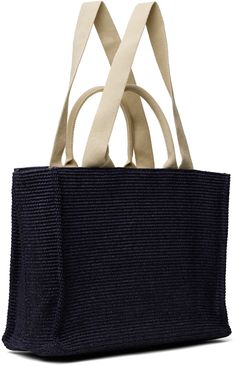 Woven faux-raffia tote in navy. · Twin rolled carry handles · Fixed webbing shoulder strap · Logo embroidered at face · Leather post-stud tab at throat · Zip pocket and logo patch at interior · Twill lining · H13 x W18 x D8 Supplier color: Ultramarine Everyday Navy Bag With Handles, Everyday Navy Bags, Navy Bag With Top Handle, Navy Shoulder Bag With Top Carry Handle For On-the-go, Navy Shopping Bag With Handles, Navy Shoulder Bag With Double Handle, Navy Rectangular Shoulder Bag With Top Carry Handle, Navy Bags With Leather Double Handles, Navy Shoulder Bag With Leather Handles For On-the-go