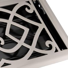 a square metal grate with an intricate design