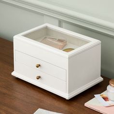 a white box sitting on top of a wooden table