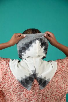 a woman covering her face with a scarf