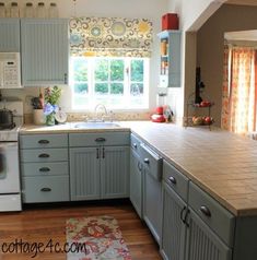 a kitchen with blue cabinets and white appliances