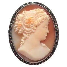 Art Deco Cameo Brooch. Fabulously carved cameo brooch made at the beginning of the 20th century, during the Art Deco era (1920-1940). It depicts a beautiful portrait of a young lady. The execution of the shell is amazing, and the relief helps to add details and dimension to the design. The frame is 800 silver with tiny marcasite inserts typical of that time. The clasp is in excellent working order. There are very slight signs of wear, but overall, the cameo is in excellent vintage pre-owned condition. This is a lovely cameo that will be admired for years to come! It is a gorgeous vintage cameo brooch with a nice size, measuring approximately 45.5 mm x 36 mm. This cameo can also be worn as a pendant. Vintage Cameo, Cameo Brooch, Art Deco Era, The 20th Century, Vintage Art Deco, The Beginning, Vintage Art, 20th Century, Shells