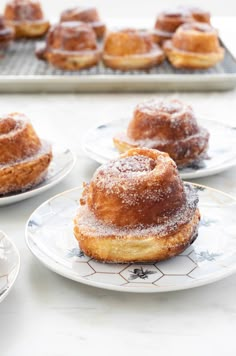 several pastries sitting on plates next to each other