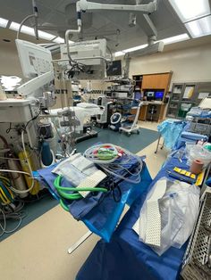 a hospital room filled with lots of medical equipment on top of a blue mat covered floor