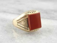 This mounting is classic style, and features gently textured shoulders and simple design. Set with a simple, richly colored red jasper, this unisex ring will make a handsome gift for a lady or a gent! Material: 10K Yellow Gold Center Stone: Red jasper 10 mm x 11.5 mm, Size of Ring: 10.5 Marks: 10K stamped on the inside of the band Brown Polished Finish Signet Ring For Formal Occasions, Formal Brown Signet Ring With Polished Finish, Classic Brown Signet Ring For Anniversary, Classic Red Signet Ring For Formal Occasions, Classic Brown Rings With Polished Finish, Classic Brown Signet Ring, Classic Red Signet Ring For Anniversary, Elegant Brown Signet Ring For Formal Occasion, Elegant Brown Signet Ring For Anniversary