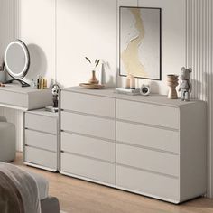 a bedroom with white furniture and accessories on the dresser next to a bed in it