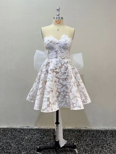 a white dress on a mannequin stand