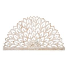 a wooden wall hanging with a large flower design on it