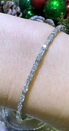 Glamour meets elegance with our 1.74ct tw diamond baguette and round alternating bracelet. Alternating diamonds in both baguette and round cuts create a stunning and unique design. Bring luxury to any outfit and make a statement with this beautiful piece. Metal: 18K White GoldDiamond Shape , Weight: (82) Round Cuts 1.89ctw, (54) Baguette Cuts 2.08ctwDiamond Total Weight: 3.97ct twBangle/Wrist Width: 53mm x 45mmBangle Width: 7mm Diamond Bracelet Design Unique, Diamond Bracelet Design, Diamond Baguette, Bracelet Design, Baguette Cut, Baguette Diamond, Bracelet Designs, Baguette, Round Cut