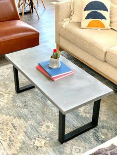 a living room with a couch, chair and coffee table in it's center